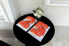 decorated table with cakes covered in strawberries that spell out 25